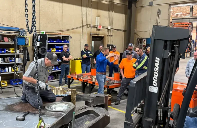 ShearCore service member demonstrating how to work on a shear with advanced service class observing