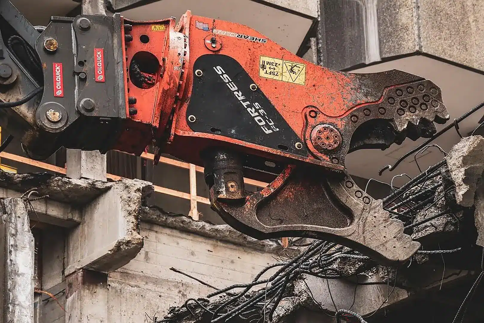 FC35 Demolition tool with OilQuick quick coupler doing demo work on rebar reinforced concrete